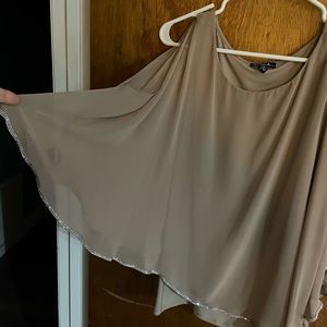 Bottom, fitted tan camisole and a sheer polyester top lined with rhinestones.